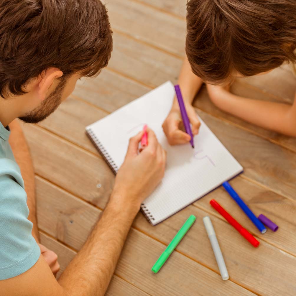 Father and Son Drawining on wooden floor